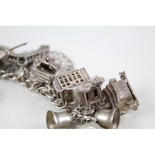 2061 - A silver charm bracelet with assorted charms - approx. gross weight 82g