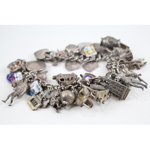 2072 - A silver charm bracelet with enamel souvenir charms - approx. gross weight 126g