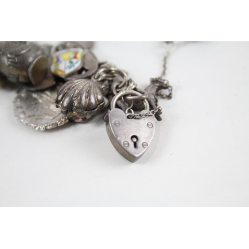 2072 - A silver charm bracelet with enamel souvenir charms - approx. gross weight 126g