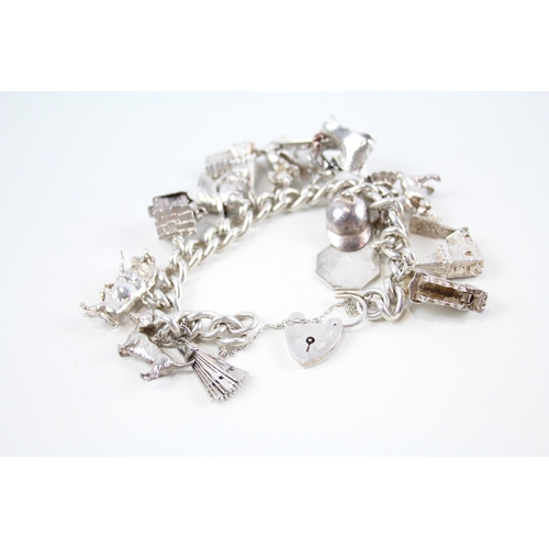 2074 - A silver charm bracelet with assorted charms - approx. gross weight 88g