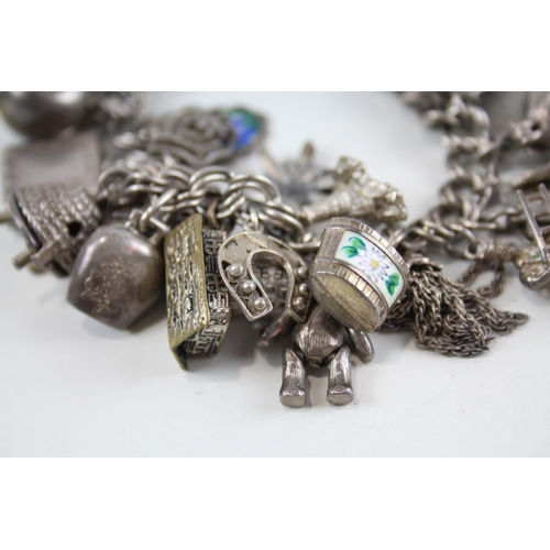 2080 - A vintage silver charm bracelet with assorted charms - approx. gross weight 99g