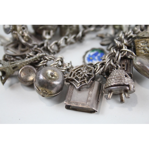 2080 - A vintage silver charm bracelet with assorted charms - approx. gross weight 99g