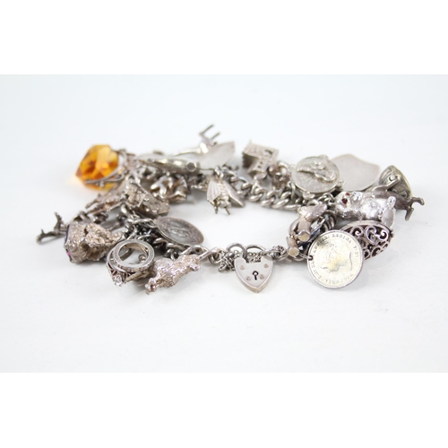 2085 - A vintage silver charm bracelet with assorted charms - approx. gross weight 115g