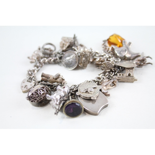 2085 - A vintage silver charm bracelet with assorted charms - approx. gross weight 115g