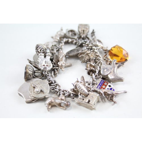 2085 - A vintage silver charm bracelet with assorted charms - approx. gross weight 115g