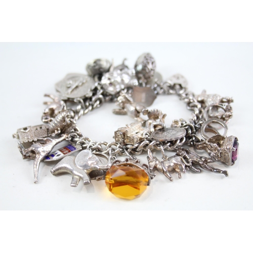 2085 - A vintage silver charm bracelet with assorted charms - approx. gross weight 115g