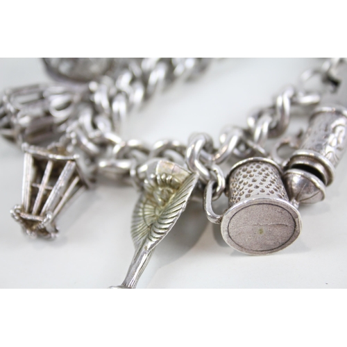 2087 - A vintage silver charm bracelet with assorted charms - approx. gross weight 121g