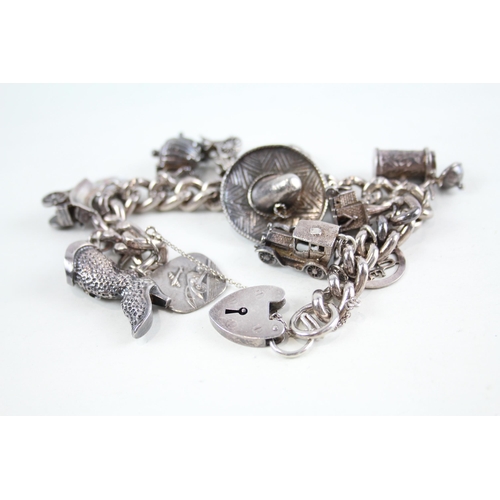 2094 - A vintage silver charm bracelet with assorted charms - approx. gross weight 106g