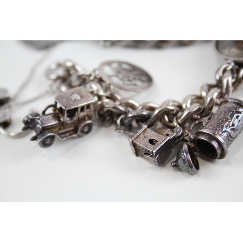 2094 - A vintage silver charm bracelet with assorted charms - approx. gross weight 106g