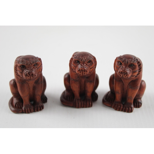 2206 - Three Oriental carved wooden zodiac tiger netsukes, signed to base