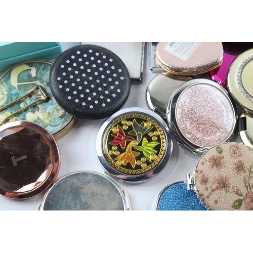 657 - A large collection of assorted compact mirrors