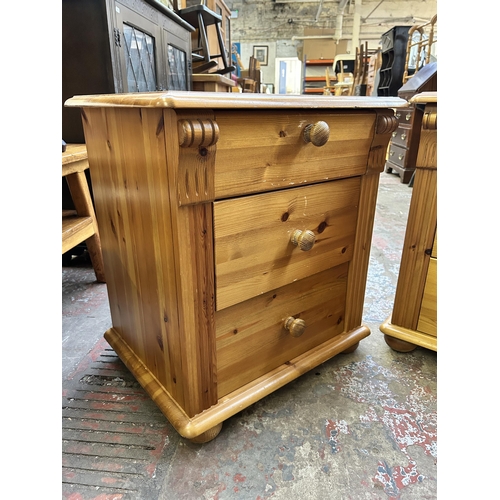 103 - A pair of pine bedside chests of drawers - approx. 61cm high x 56cm wide x 42cm deep