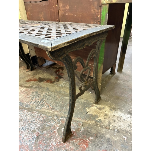 104 - A modern cast iron and wood garden table - approx. 66cm high x 57cm wide x 116cm long