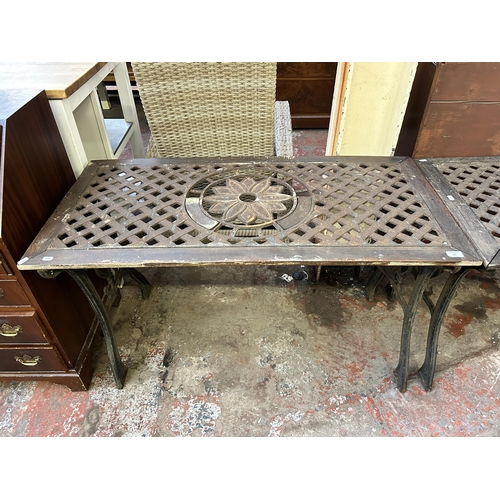 105 - A modern cast iron and wood garden table - approx. 66cm high x 57cm wide x 116cm long