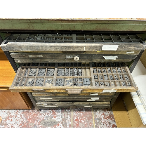 11 - A mid 20th century black painted steel printer's cabinet containing nineteen wooden printer's trays ... 