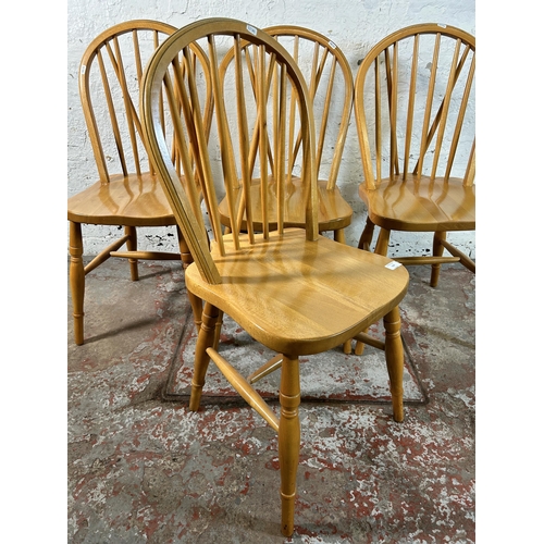 117 - Four beech Windsor dining chairs