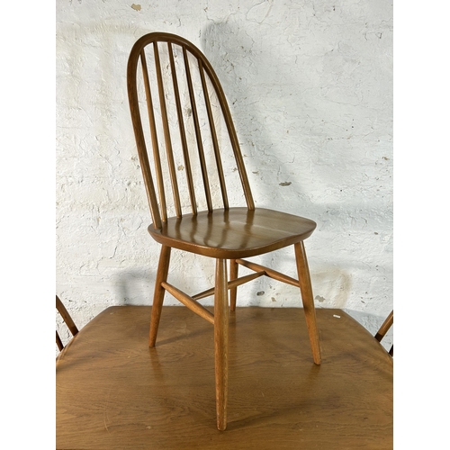 120 - An Ercol style elm and beech drop leaf oval dining table and three chairs