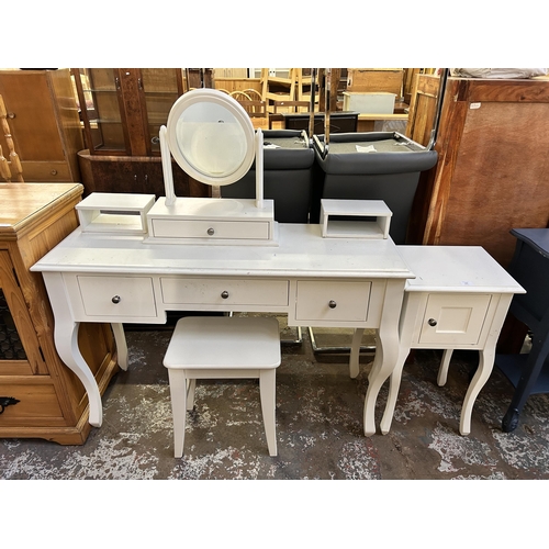 126 - A Laura Ashley white painted dressing table and bedside cabinet