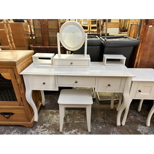 126 - A Laura Ashley white painted dressing table and bedside cabinet