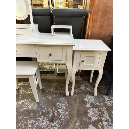 126 - A Laura Ashley white painted dressing table and bedside cabinet