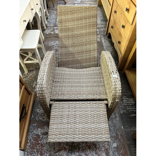 130 - A plastic rattan effect reclining garden sun lounger armchair