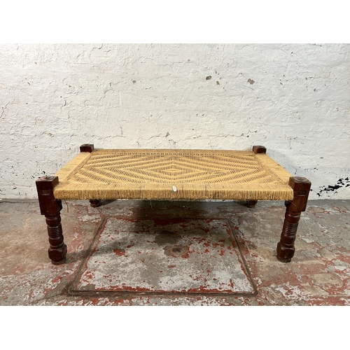 150 - A South Asian traditional woven and hardwood charpai - approx. 40cm high x 60cm wide x 110cm long