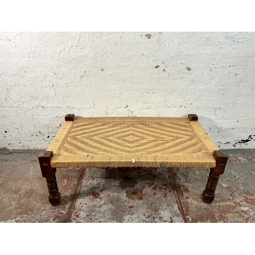 150 - A South Asian traditional woven and hardwood charpai - approx. 40cm high x 60cm wide x 110cm long