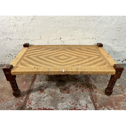 150 - A South Asian traditional woven and hardwood charpai - approx. 40cm high x 60cm wide x 110cm long