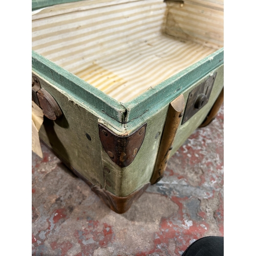 27 - An early 20th century green canvas and fibreboard travel trunk with beech and leather banding, stamp... 