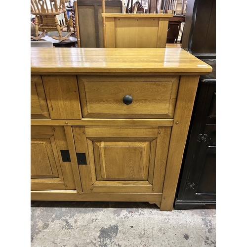 35 - A modern solid oak sideboard - approx. 96cm high x 126cm wide x 48cm deep