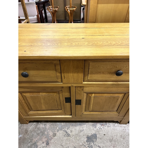 35 - A modern solid oak sideboard - approx. 96cm high x 126cm wide x 48cm deep