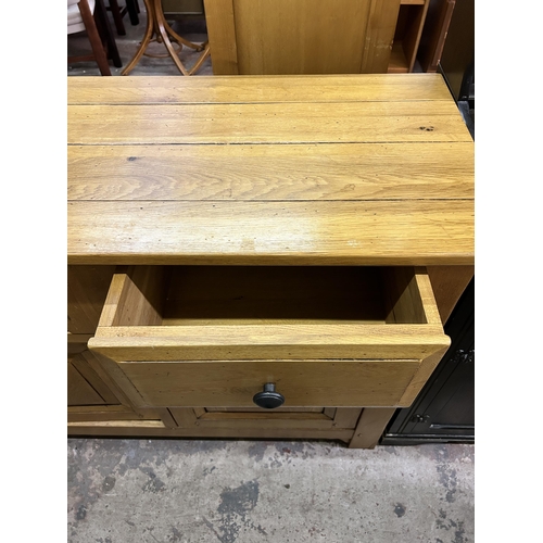 35 - A modern solid oak sideboard - approx. 96cm high x 126cm wide x 48cm deep