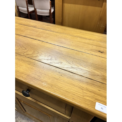 35 - A modern solid oak sideboard - approx. 96cm high x 126cm wide x 48cm deep