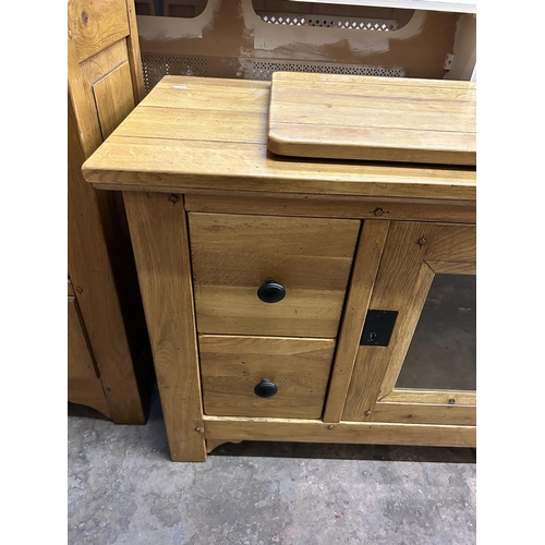 36 - A modern solid oak TV cabinet - approx. 78cm high x 118cm wide x 48cm deep