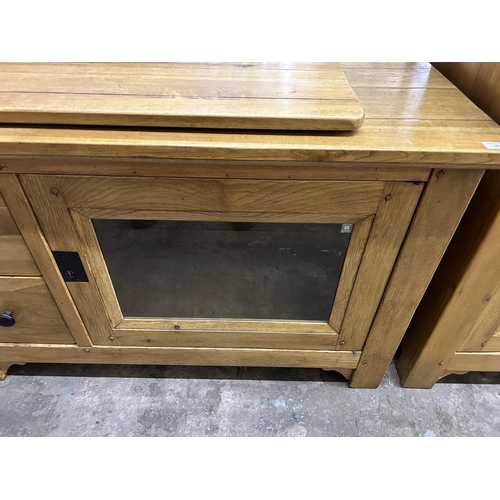 36 - A modern solid oak TV cabinet - approx. 78cm high x 118cm wide x 48cm deep