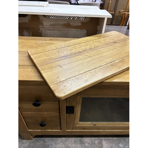 36 - A modern solid oak TV cabinet - approx. 78cm high x 118cm wide x 48cm deep