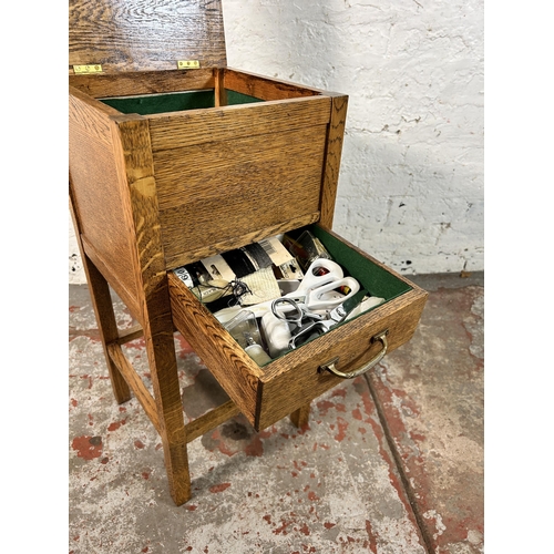 40 - A 1930s oak sewing table - approx. 66cm high x 32cm wide x 31cm deep