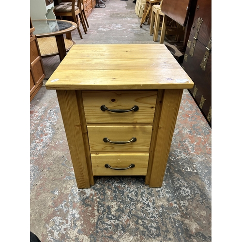 42 - A pine bedside chest of drawers