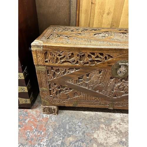 43 - A Chinese carved camphorwood and brass bound chest stamped 