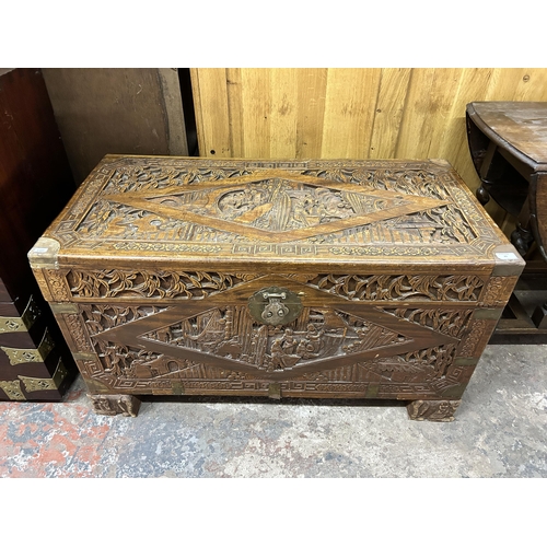 43 - A Chinese carved camphorwood and brass bound chest stamped 