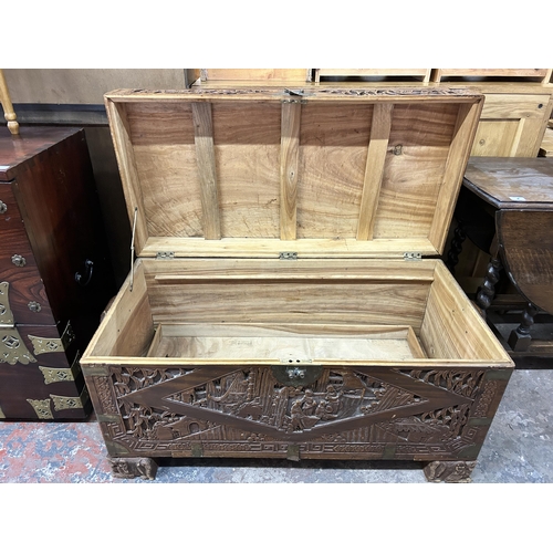 43 - A Chinese carved camphorwood and brass bound chest stamped 