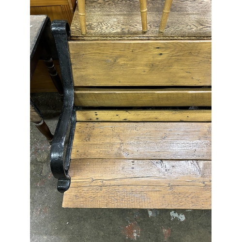 49 - A Victorian cast iron and reclaimed oak garden bench - approx. 86cm high x 245cm wide x 85cm deep