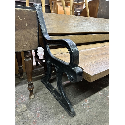 49 - A Victorian cast iron and reclaimed oak garden bench - approx. 86cm high x 245cm wide x 85cm deep