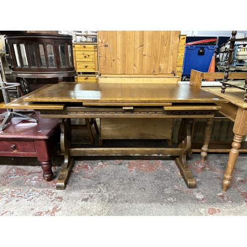 57 - A carved oak draw leaf dining table