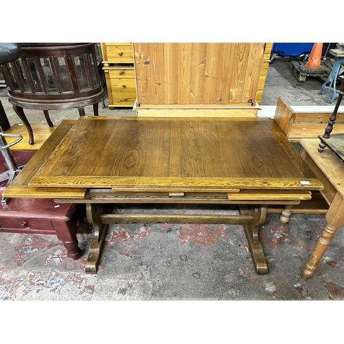 57 - A carved oak draw leaf dining table