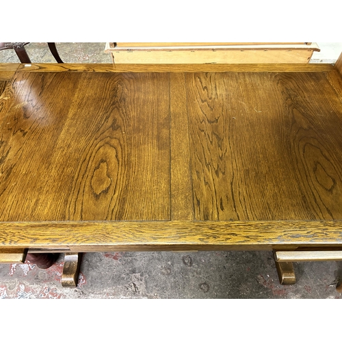 57 - A carved oak draw leaf dining table