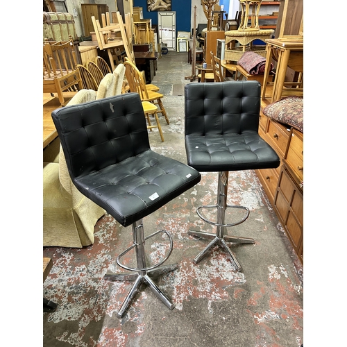 59 - A pair of modern black leatherette and chrome plated bar stools