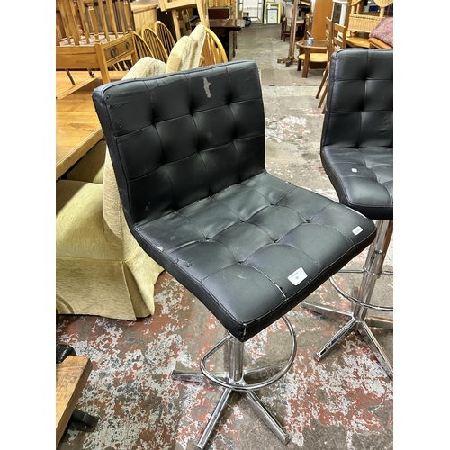 59 - A pair of modern black leatherette and chrome plated bar stools