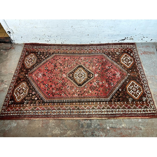 63 - A Persian style machine woven rug - approx. 252cm x 164cm