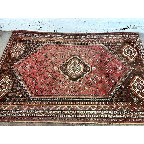 63 - A Persian style machine woven rug - approx. 252cm x 164cm